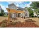 Charming backyard showcasing a wooden pergola, creating a perfect outdoor living space and an inviting atmosphere at 116 Dallavia Ct, Morrisville, NC 27560