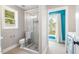 Modern bathroom featuring a glass-enclosed shower with stylish tile, a toilet, and a bright window at 116 Dallavia Ct, Morrisville, NC 27560