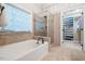 Bathroom featuring a tiled shower, a soaking tub, tiled floors, and a walk-in closet at 116 Dallavia Ct, Morrisville, NC 27560