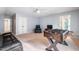 Spacious carpeted bedroom with ceiling fan, entertainment center, and foosball table for relaxation and recreation at 116 Dallavia Ct, Morrisville, NC 27560