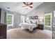 Spacious bedroom features vaulted ceilings, a ceiling fan, three windows, and neutral carpet at 116 Dallavia Ct, Morrisville, NC 27560