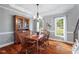 Classic dining room with hardwood floors, a wooden table, and stylish chandelier at 116 Dallavia Ct, Morrisville, NC 27560