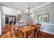 Formal dining room with hardwood floors, elegant chandelier, and traditional decor at 116 Dallavia Ct, Morrisville, NC 27560