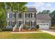 Beautiful two-story home featuring a manicured lawn, attached two-car garage, and classic curb appeal at 116 Dallavia Ct, Morrisville, NC 27560