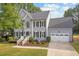 Charming home with a well-maintained lawn, white trim, black shutters, and a two-car attached garage at 116 Dallavia Ct, Morrisville, NC 27560