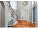 Bright foyer with hardwood floors, staircase, and large windows allowing natural light to fill the area at 116 Dallavia Ct, Morrisville, NC 27560
