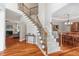 Elegant foyer with hardwood floors, wrought iron staircase, open floor plan, and elegant chandelier at 116 Dallavia Ct, Morrisville, NC 27560