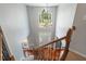 Bright foyer with hardwood floors, staircase, large arched window, chandelier, and entry door at 116 Dallavia Ct, Morrisville, NC 27560