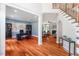 Home office featuring hardwood floors, a large desk, custom bookcases, and bright blue walls at 116 Dallavia Ct, Morrisville, NC 27560
