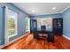 Bright home office with hardwood floors, a large window, a desk, and built-in shelving at 116 Dallavia Ct, Morrisville, NC 27560