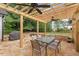 Outdoor patio with a wooden pergola and ceiling fans providing a comfortable dining and entertaining space at 116 Dallavia Ct, Morrisville, NC 27560