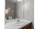 Half-bathroom features a decorative mirror, vanity, and sink with traditional hardware at 120 Foley Dr, Garner, NC 27529