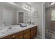 Bathroom with double vanity, decorative nautical touches, and large well-lit mirror at 120 Foley Dr, Garner, NC 27529