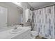 Bathroom with white vanity, toilet, and tub/shower combination with modern curtain at 120 Foley Dr, Garner, NC 27529