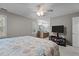Spacious bedroom with sitting area, television, and view into the ensuite bathroom at 120 Foley Dr, Garner, NC 27529