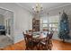 Bright dining room with a wooden table, six chairs, chandelier, and natural light from the window at 120 Foley Dr, Garner, NC 27529