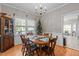 Charming dining room with a wooden table, six chairs, chandelier, and views to the outdoor deck at 120 Foley Dr, Garner, NC 27529