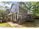 Exterior of a two-story gray home with wood fence, bay window, back deck, and screened-in porch at 120 Foley Dr, Garner, NC 27529