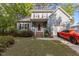 Charming two-story home with gray siding, brick accents, and a well-manicured front yard at 120 Foley Dr, Garner, NC 27529