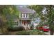 Two-story home with a red front door, attached garage, and a vibrant red car, surrounded by lush greenery at 120 Foley Dr, Garner, NC 27529