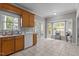 Bright kitchen featuring wooden cabinets, stainless steel sink, and bay windows with a view to the backyard at 120 Foley Dr, Garner, NC 27529