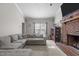Cozy living room with a large sectional sofa, brick fireplace, and a flat-screen television at 120 Foley Dr, Garner, NC 27529
