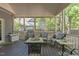Screened porch includes outdoor seating, a ceiling, and a peek into the wooded backyard at 120 Foley Dr, Garner, NC 27529