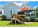 A backyard deck features stairs and a grill, with a screened-in porch in this inviting outdoor space at 120 Mearleaf Pl, Holly Springs, NC 27540