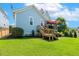 A backyard view of a deck and screened-in porch, with a lovely lawn and blue siding on the home at 120 Mearleaf Pl, Holly Springs, NC 27540