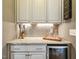 Convenient wet bar featuring granite countertops, custom cabinets, and a wine refrigerator at 120 Mearleaf Pl, Holly Springs, NC 27540