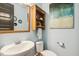 Charming powder room with a modern sink, toilet, and beach-themed decor for a refreshing ambiance at 120 Mearleaf Pl, Holly Springs, NC 27540