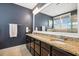 Stylish bathroom with granite countertop, double sinks, dark wood cabinets, and ample lighting at 120 Mearleaf Pl, Holly Springs, NC 27540