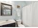 Clean bathroom featuring a sink, toilet, and shower with a white curtain at 120 Mearleaf Pl, Holly Springs, NC 27540
