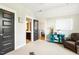 Bedroom with a blue entertainment center, dark doors, and view of the hallway at 120 Mearleaf Pl, Holly Springs, NC 27540