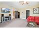 Bonus room featuring a mountain scene on TV and a comfortable red couch at 120 Mearleaf Pl, Holly Springs, NC 27540