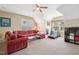 Bonus room featuring a red sectional sofa and treadmill workout area at 120 Mearleaf Pl, Holly Springs, NC 27540