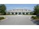 Attractive white clubhouse exterior with multiple gables and symmetrical design elements at 120 Mearleaf Pl, Holly Springs, NC 27540