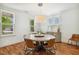 Bright dining room with a round table, hardwood floors, and plenty of natural light from the windows at 120 Mearleaf Pl, Holly Springs, NC 27540