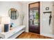 Stylish entryway with hardwood floors, a decorative mirror, and ample space for storage at 120 Mearleaf Pl, Holly Springs, NC 27540