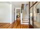 Elegant foyer with hardwood floors, a staircase, and an open view into the living spaces at 120 Mearleaf Pl, Holly Springs, NC 27540