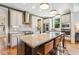 Bright kitchen with granite countertops, stainless appliances, and large central island at 120 Mearleaf Pl, Holly Springs, NC 27540