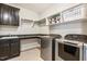 Well-organized laundry room with sink, countertop, storage, and modern washer and dryer for efficient chores at 120 Mearleaf Pl, Holly Springs, NC 27540