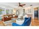 Spacious living room with hardwood floors, plush seating, and natural light from large windows at 120 Mearleaf Pl, Holly Springs, NC 27540