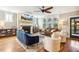 Comfortable living room with fireplace, large windows, and hardwood flooring throughout at 120 Mearleaf Pl, Holly Springs, NC 27540