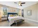 Serene main bedroom featuring a plush blue bed, natural light, and stylish decor at 120 Mearleaf Pl, Holly Springs, NC 27540