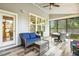 Relaxing sunroom with wood look flooring, comfortable seating, and abundant natural light at 120 Mearleaf Pl, Holly Springs, NC 27540