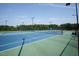 Well-maintained tennis courts with blue and green playing surfaces and surrounding trees at 120 Mearleaf Pl, Holly Springs, NC 27540