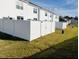 Fenced backyard offering privacy, with white vinyl fencing and a well-maintained lawn at 121 N Chubb Rdg, Wilson's Mills, NC 27520