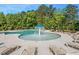 Exterior shot of a large community pool with lounge chairs and a waterfall feature at 121 N Chubb Rdg, Wilson's Mills, NC 27520