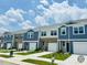 Charming townhomes feature a mix of brick and siding exteriors with attached garages and manicured lawns at 121 N Chubb Rdg, Wilson's Mills, NC 27520